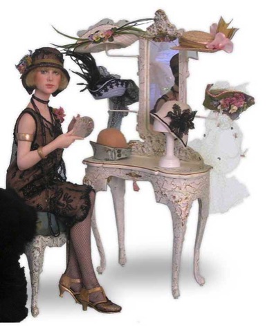 1920 art deco era doll dressed in coffeeand balck beaded lace dress seated a dressing table with hats|CATNCO